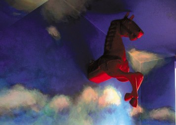 A red horse flies in the blue sky with clouds
